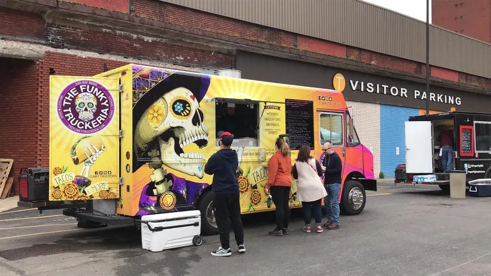 The Funky Truckeria food truck serving a line of customers at an event